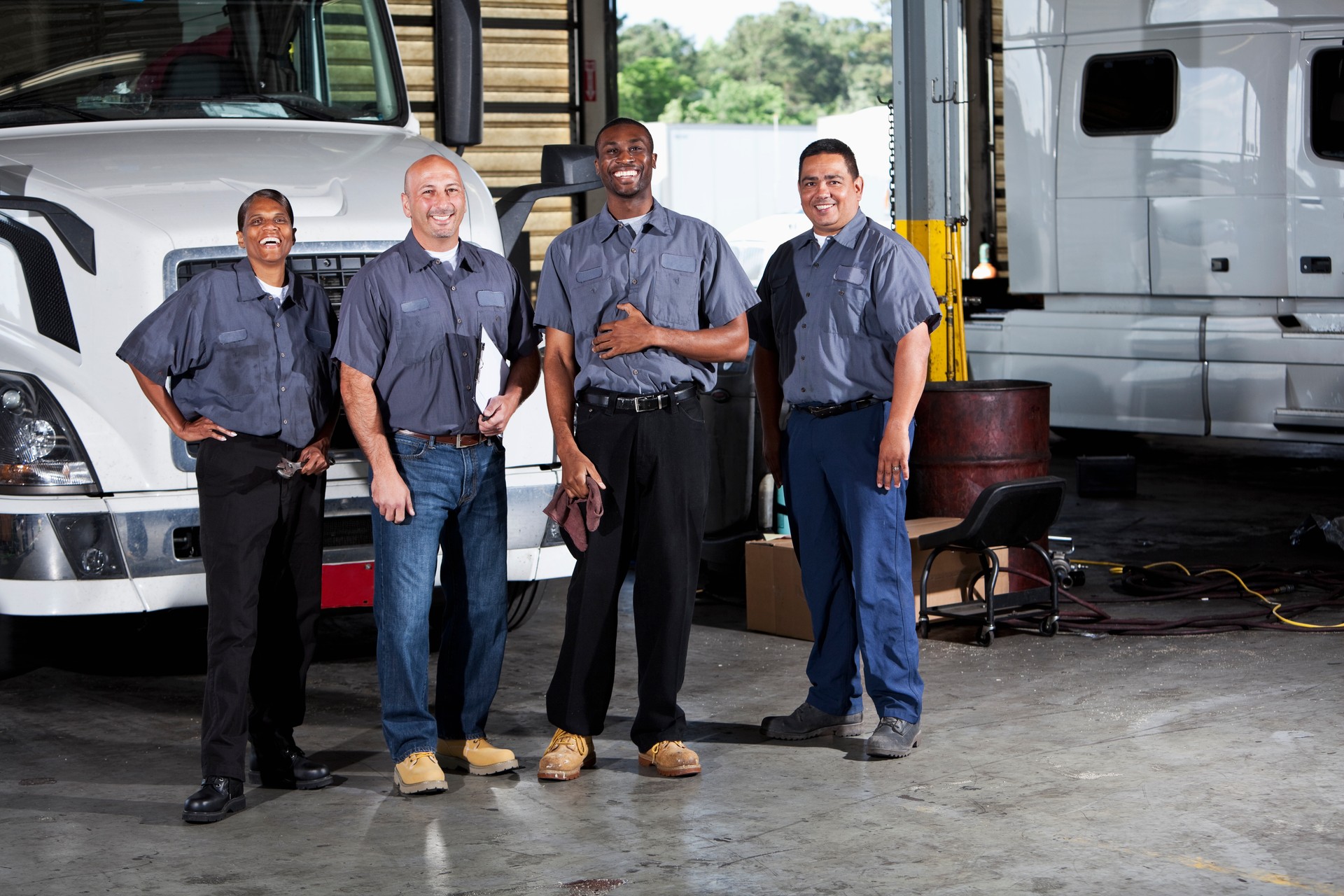 Multi-ethnic workers at trucking facility